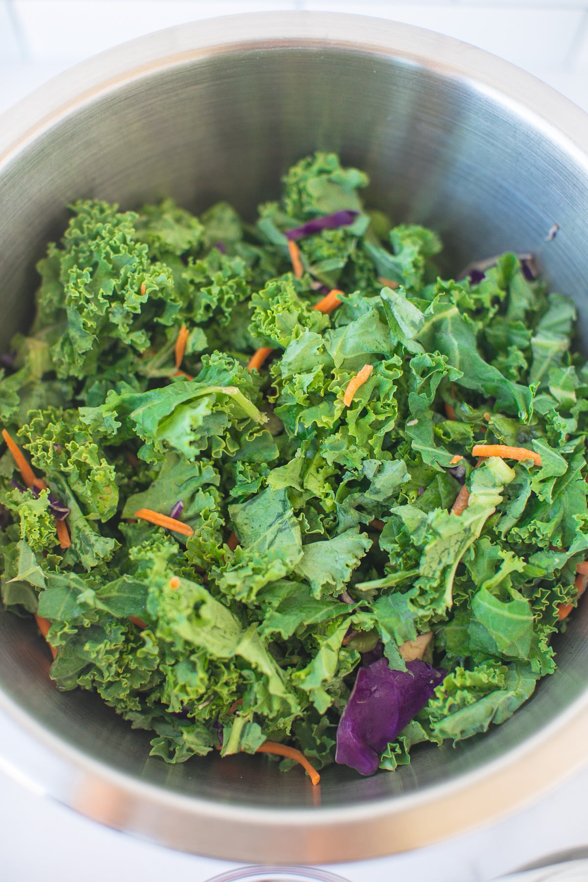 bowl of shredded kale salad with no dressing.