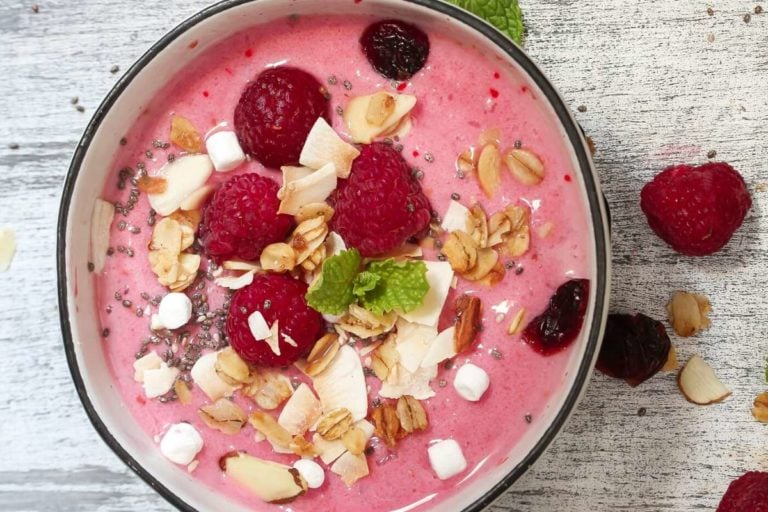 raspberry smoothie bowl with granola on top