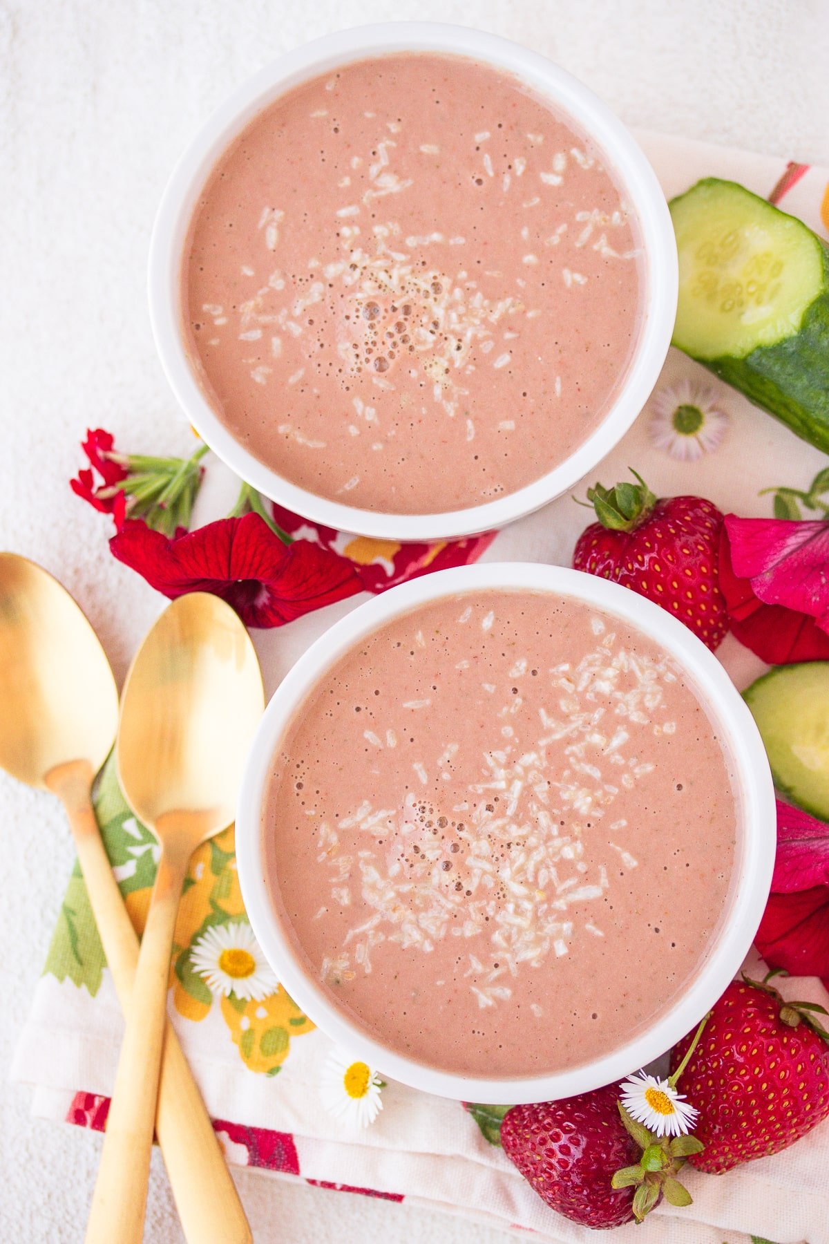 two bowls of cold strawberry soup ready to be eaten.