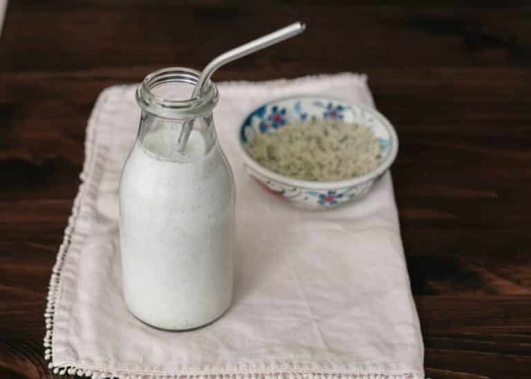 hemp milk in a jar with silver straw.