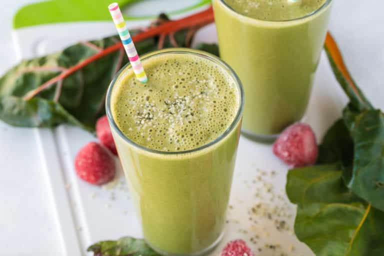 swiss chard smoothie with straw.