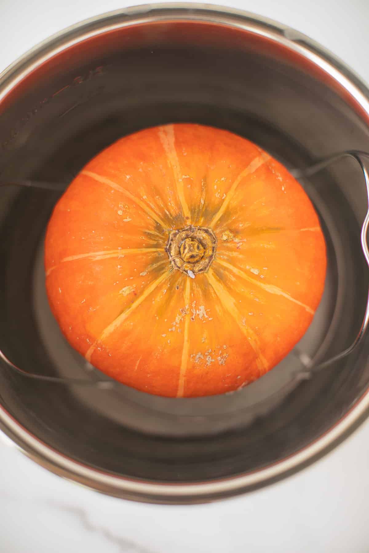 orange kabocha squash in an instant pot ready to be cooked.