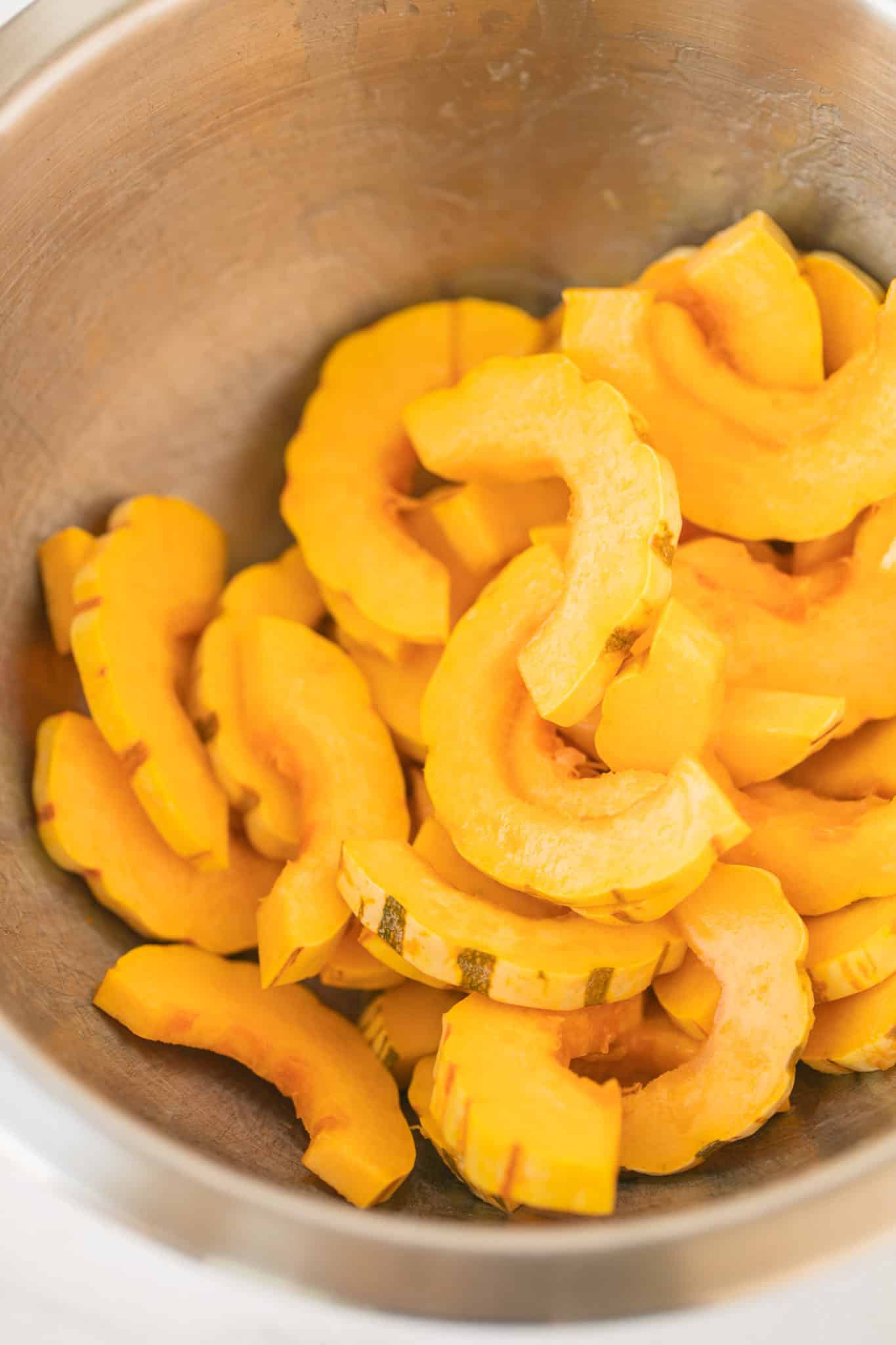 sliced delicata squash in a bowl.