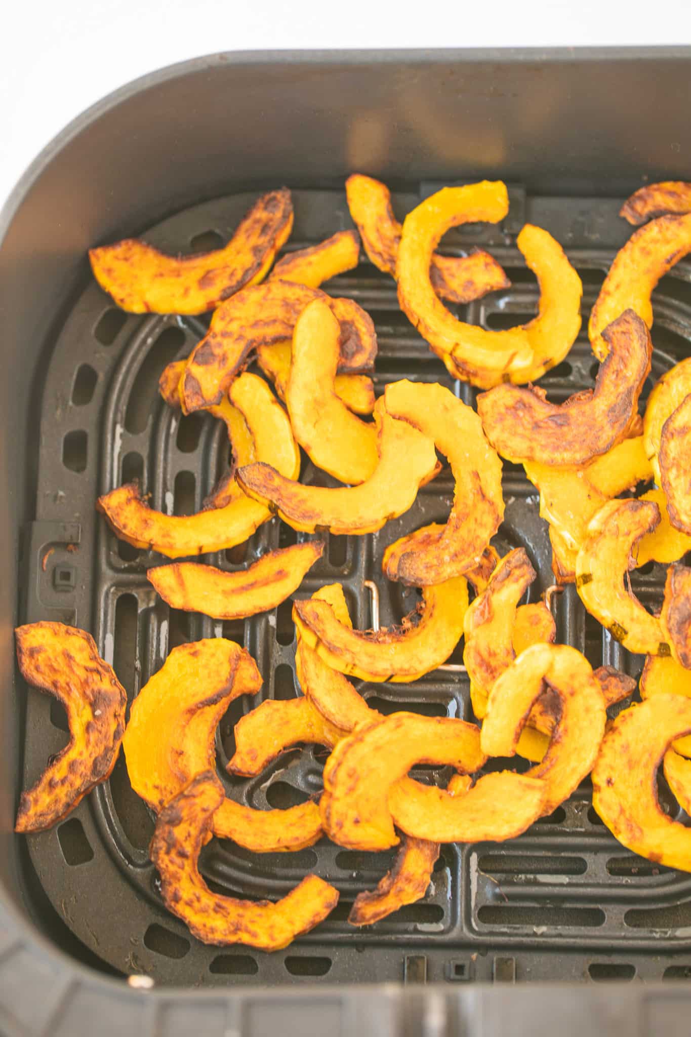 baked squash in air fryer basket.