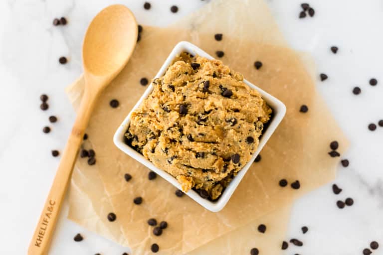 bowl of chocolate chip chickpea cookie dough surrounded by chocolate chips