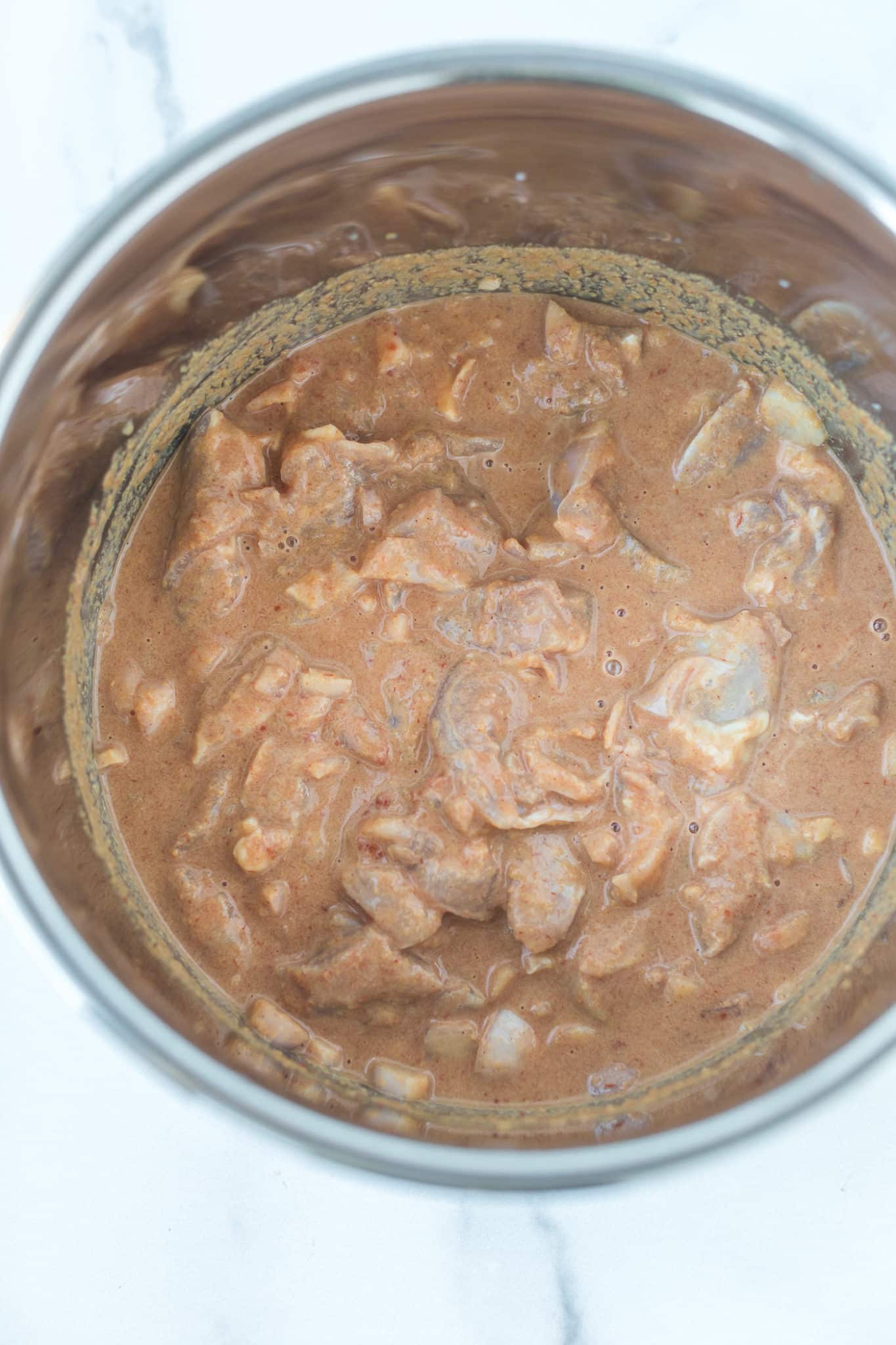 ingredients for instant pot peanut chicken in a pot.