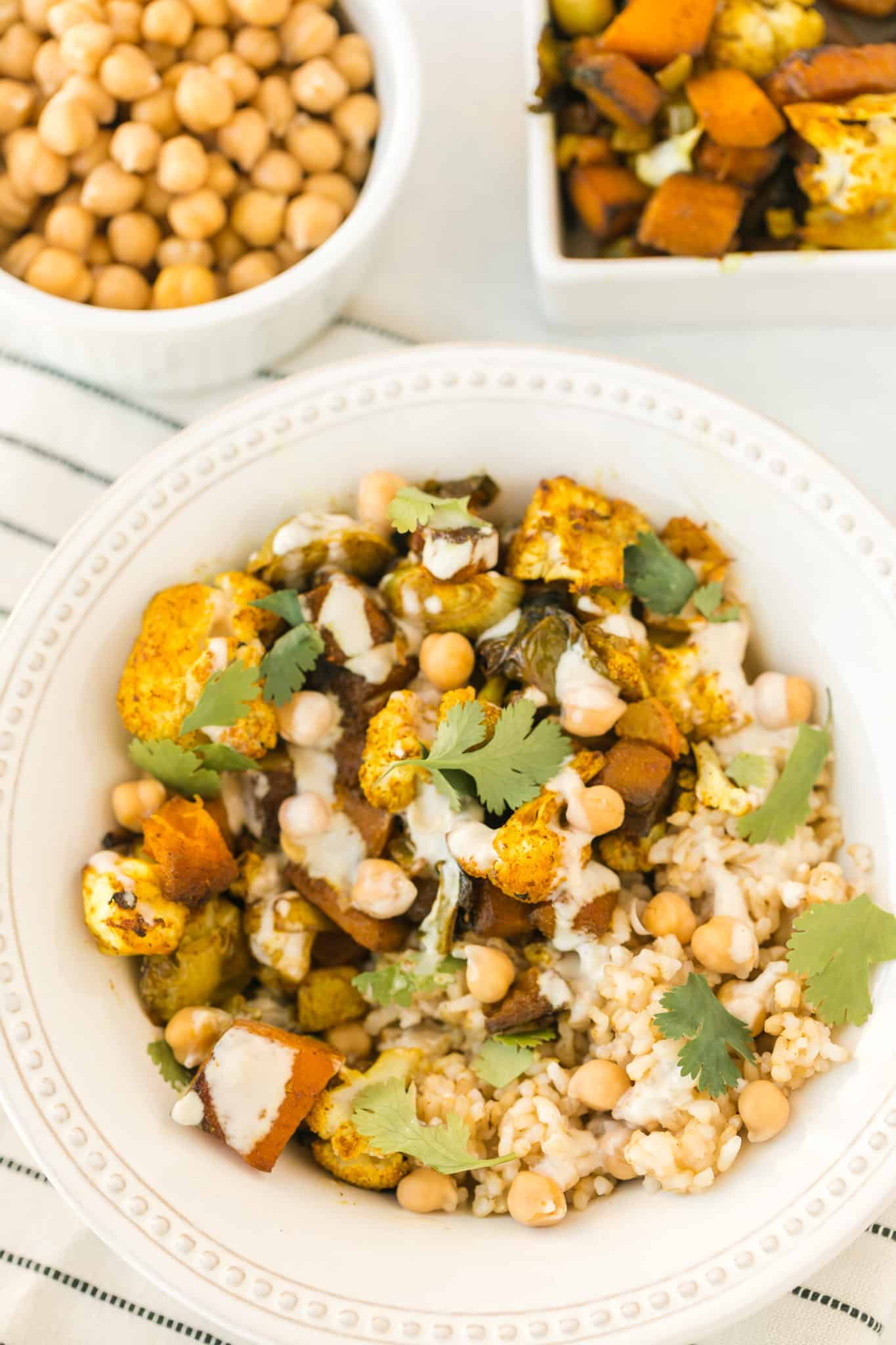 anti-inflammatory veggie bowl served with chickpeas and a tahini drizzle.