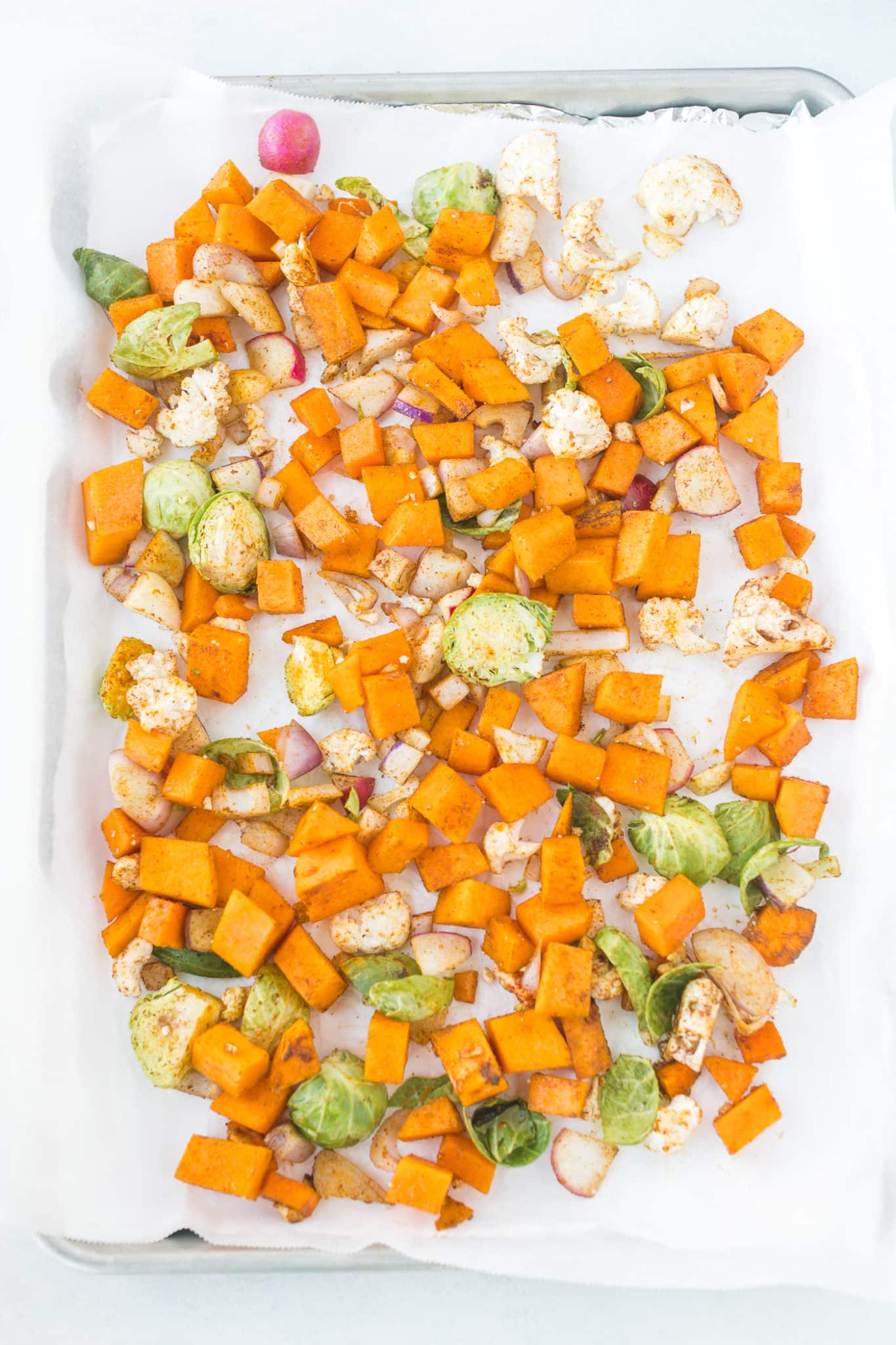 vegetables on baking sheet ready for roasting in the oven.