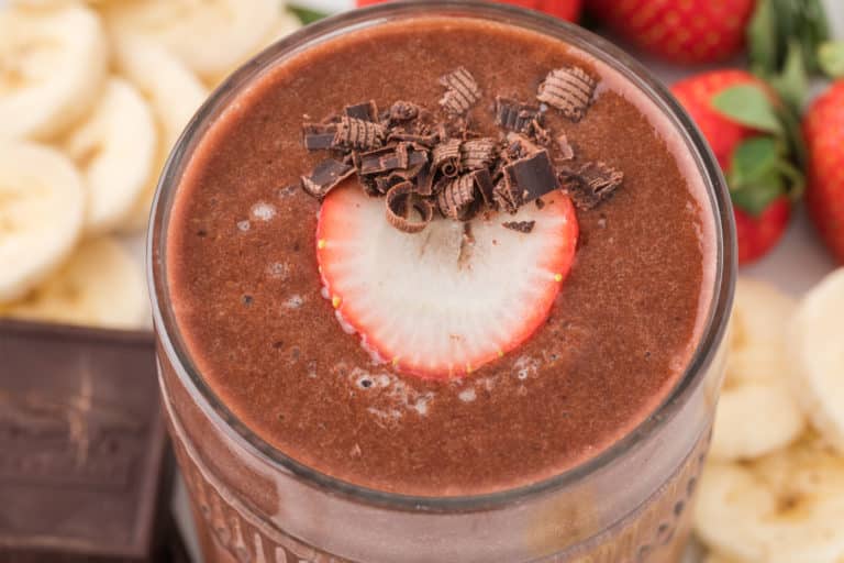 strawberry banana chocolate smoothie in glass.