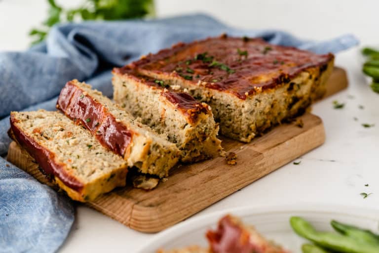 chicken meatloaf cooked and sliced on a cutting board