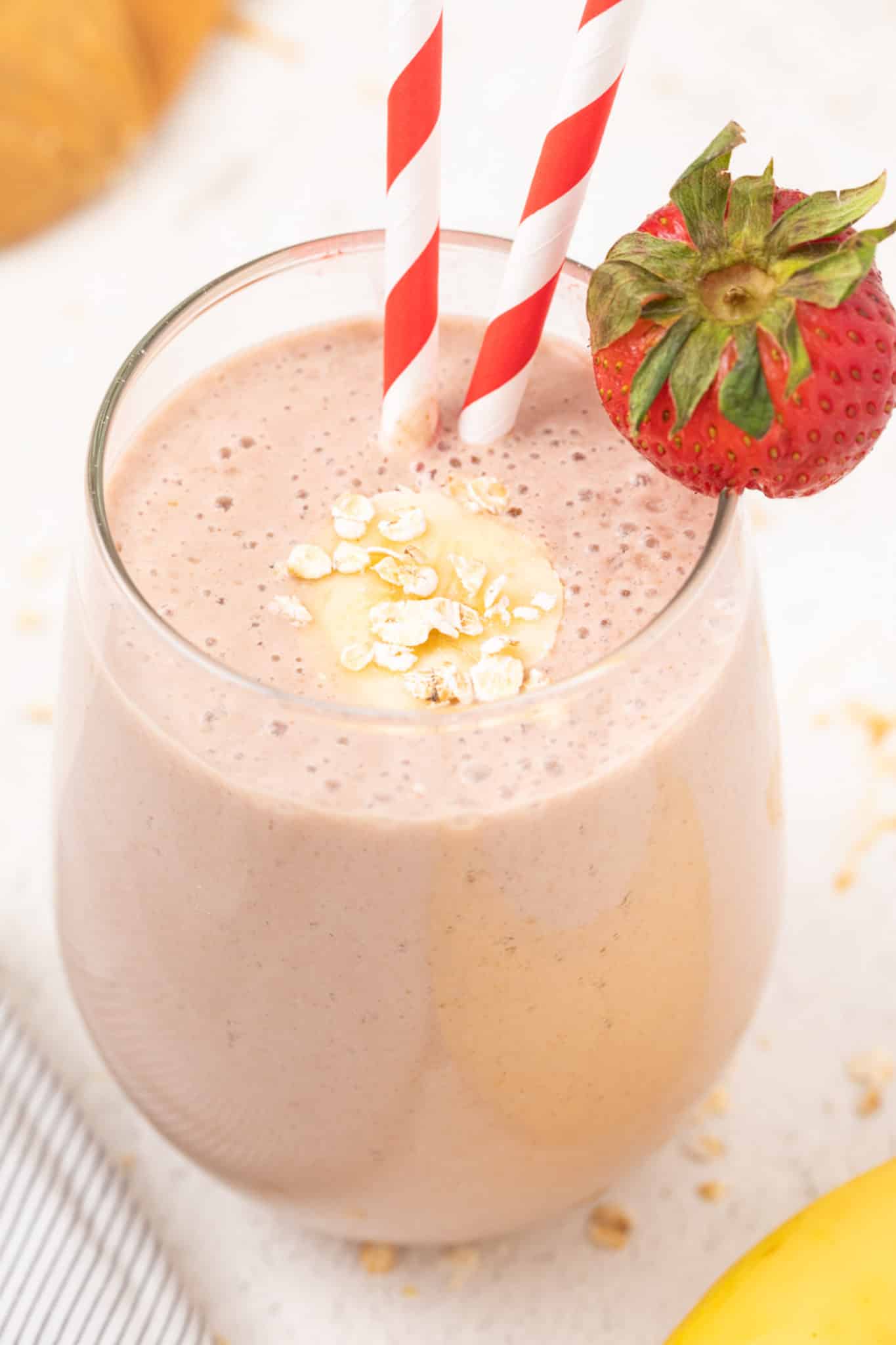 Oat milk strawberry banana smoothie served in a glass.