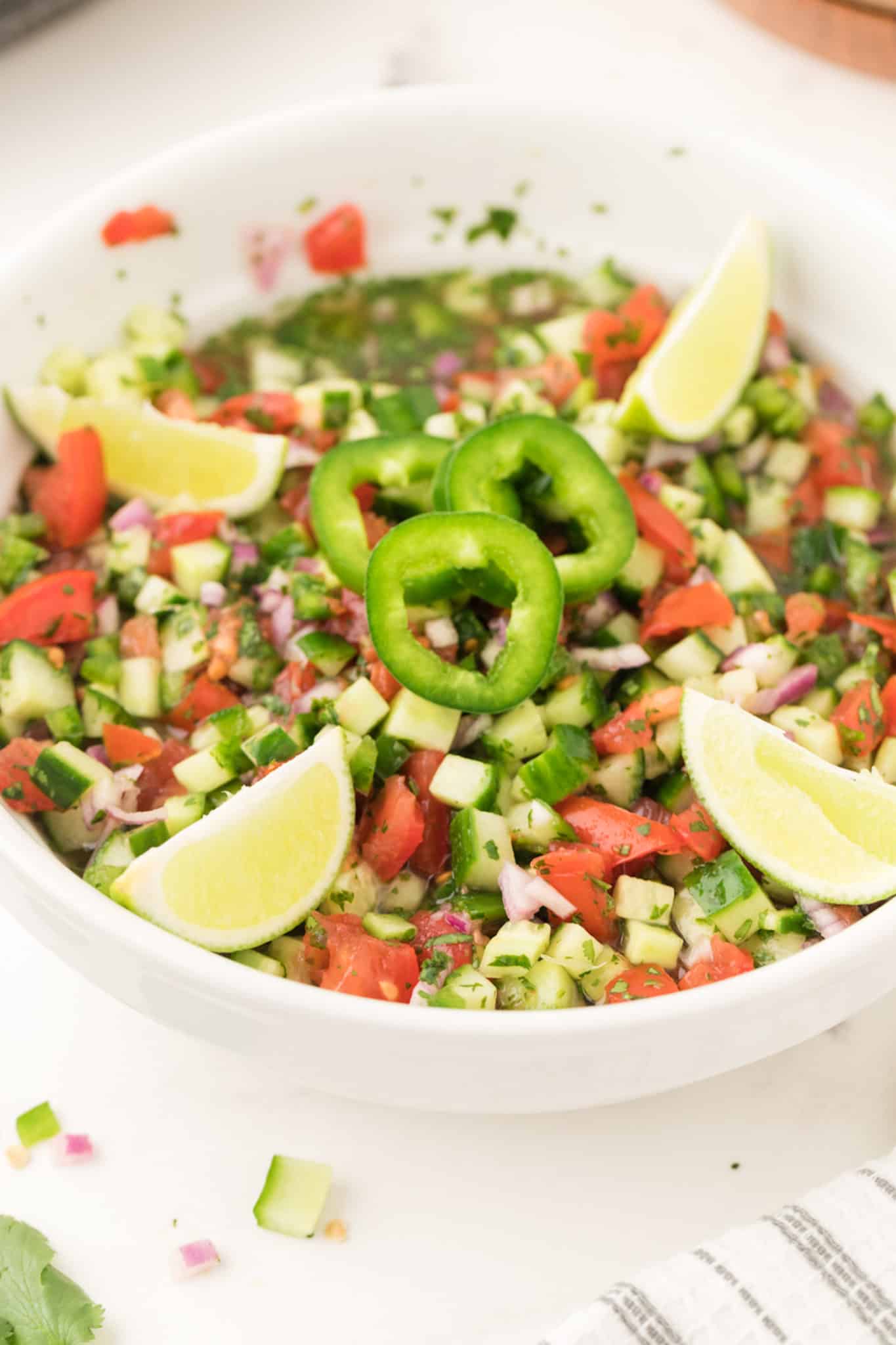 A bowl of cucumber pico de gallo with jalapenos