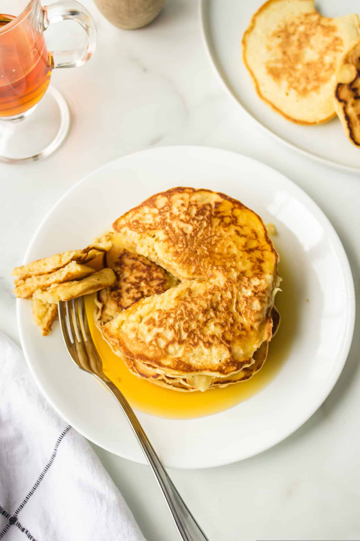 plate of coconut milk pancakes with a fork.