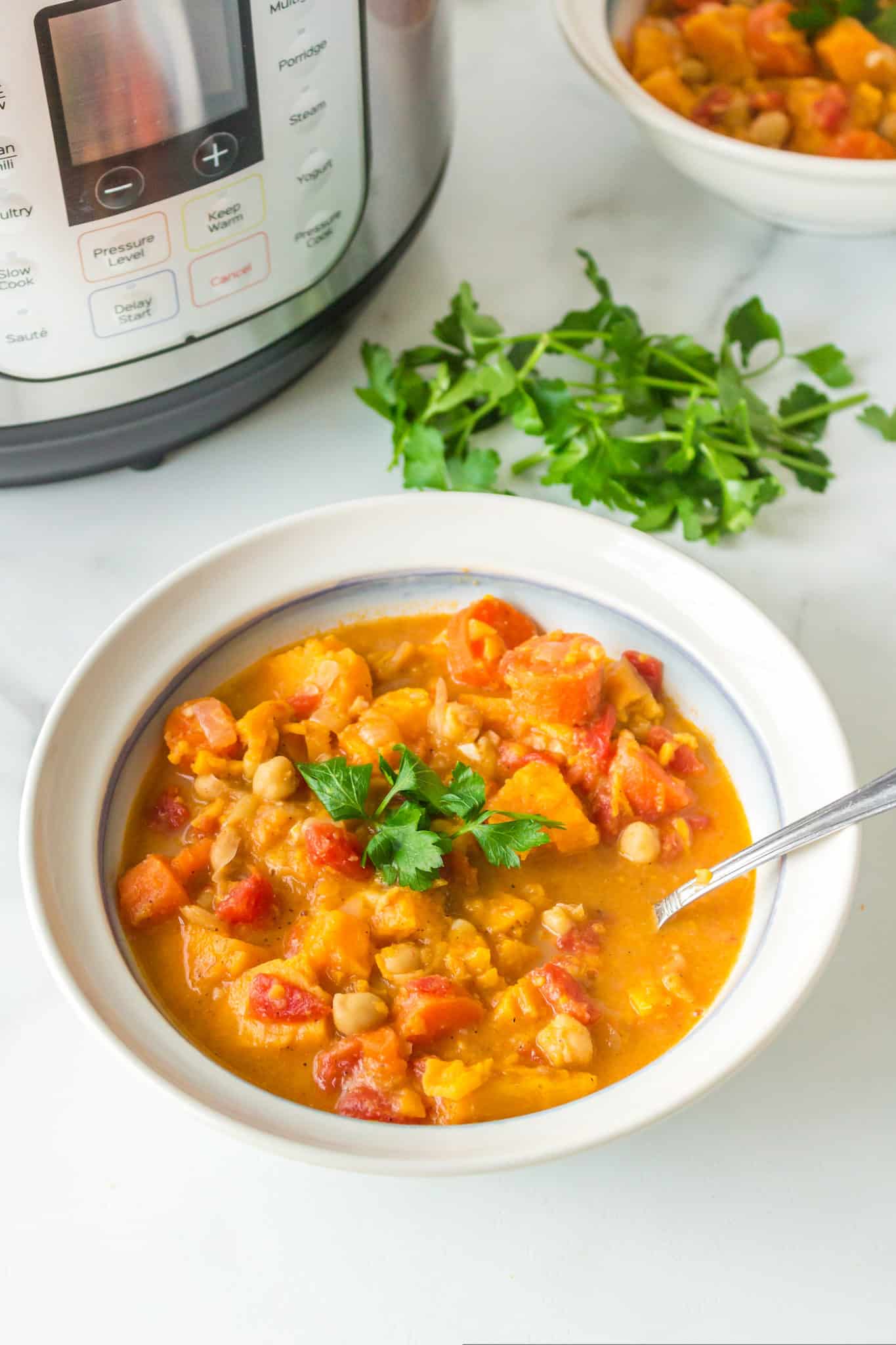 A bowl of instant pot vegan stew topped with fresh parsley.