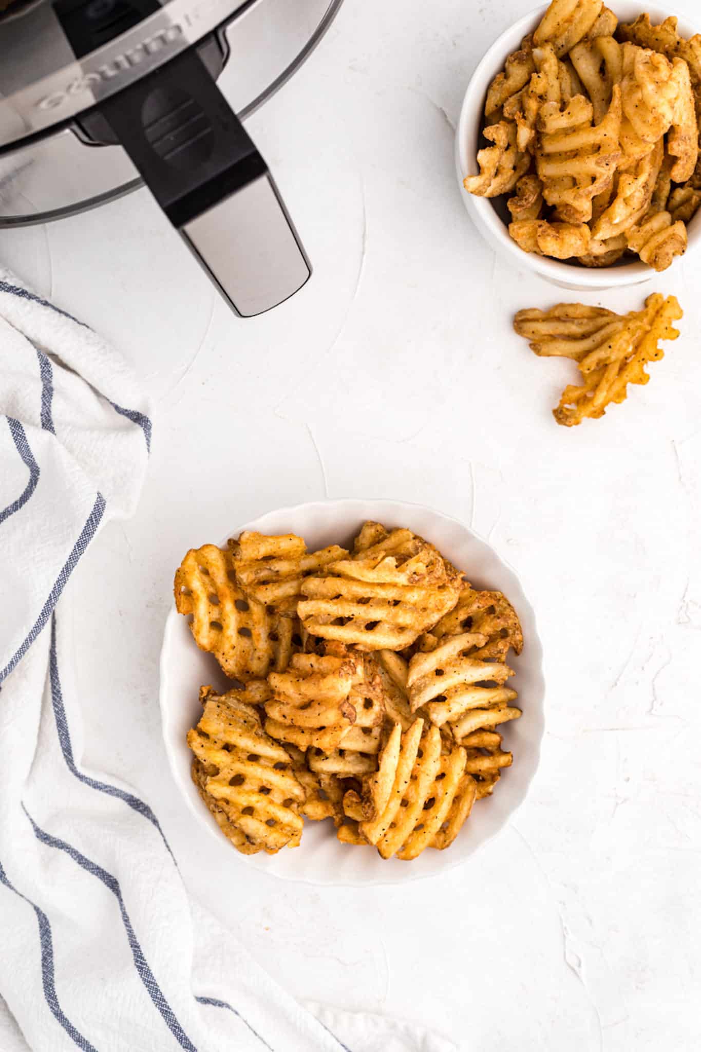 waffle fries served in two bowls.