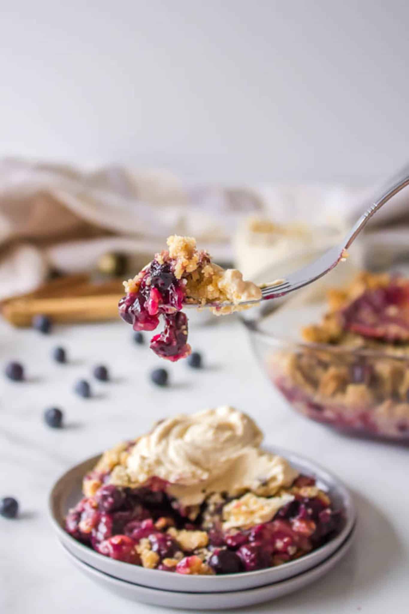 bite of blueberry dessert with whipped topping.