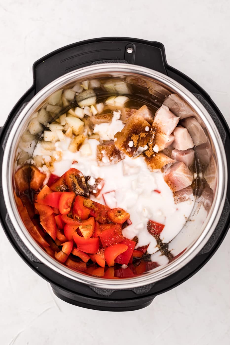 instant pot with mahi mahi, bell pepper, and coconut milk.