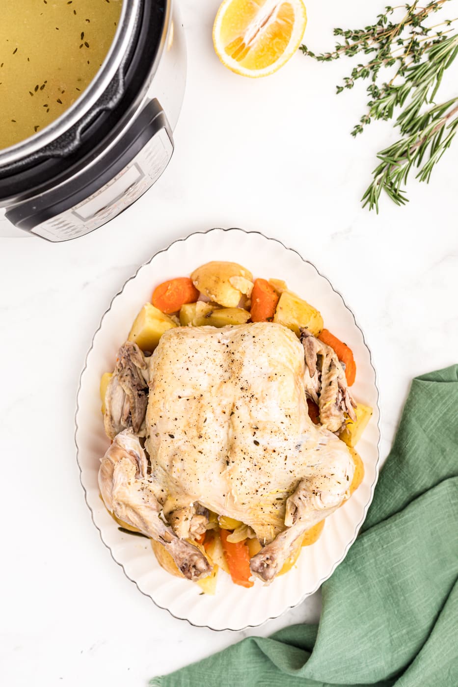 whole chicken with potatoes and carrots.