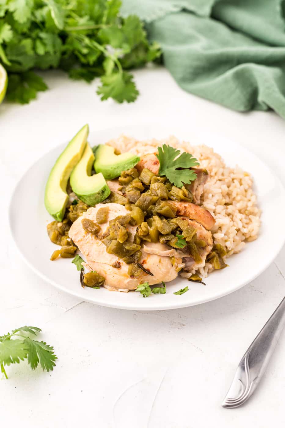 crockpot chicken thighs with green chiles on table.