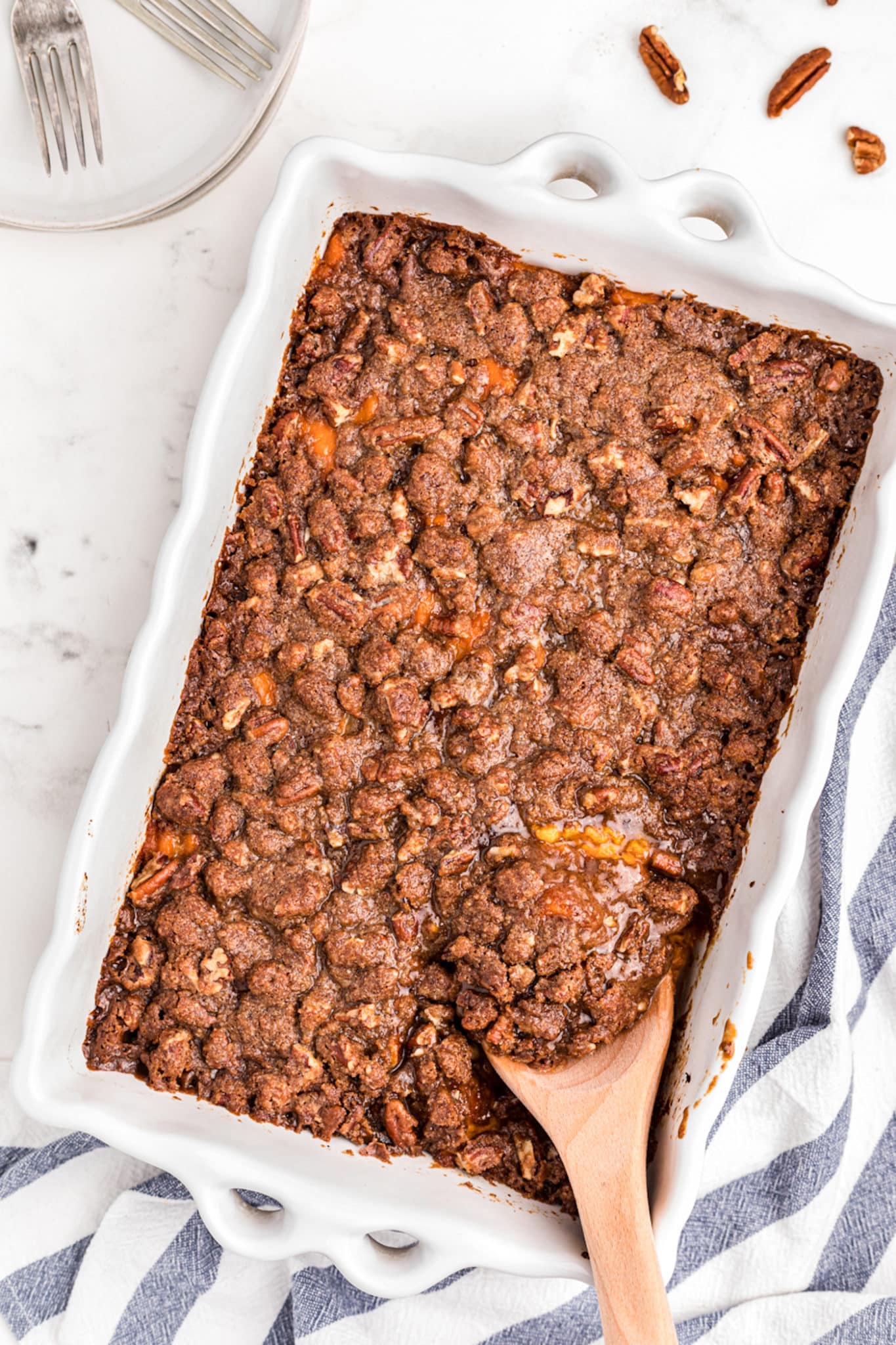 gluten free sweet potato casserole served in white baking dish.