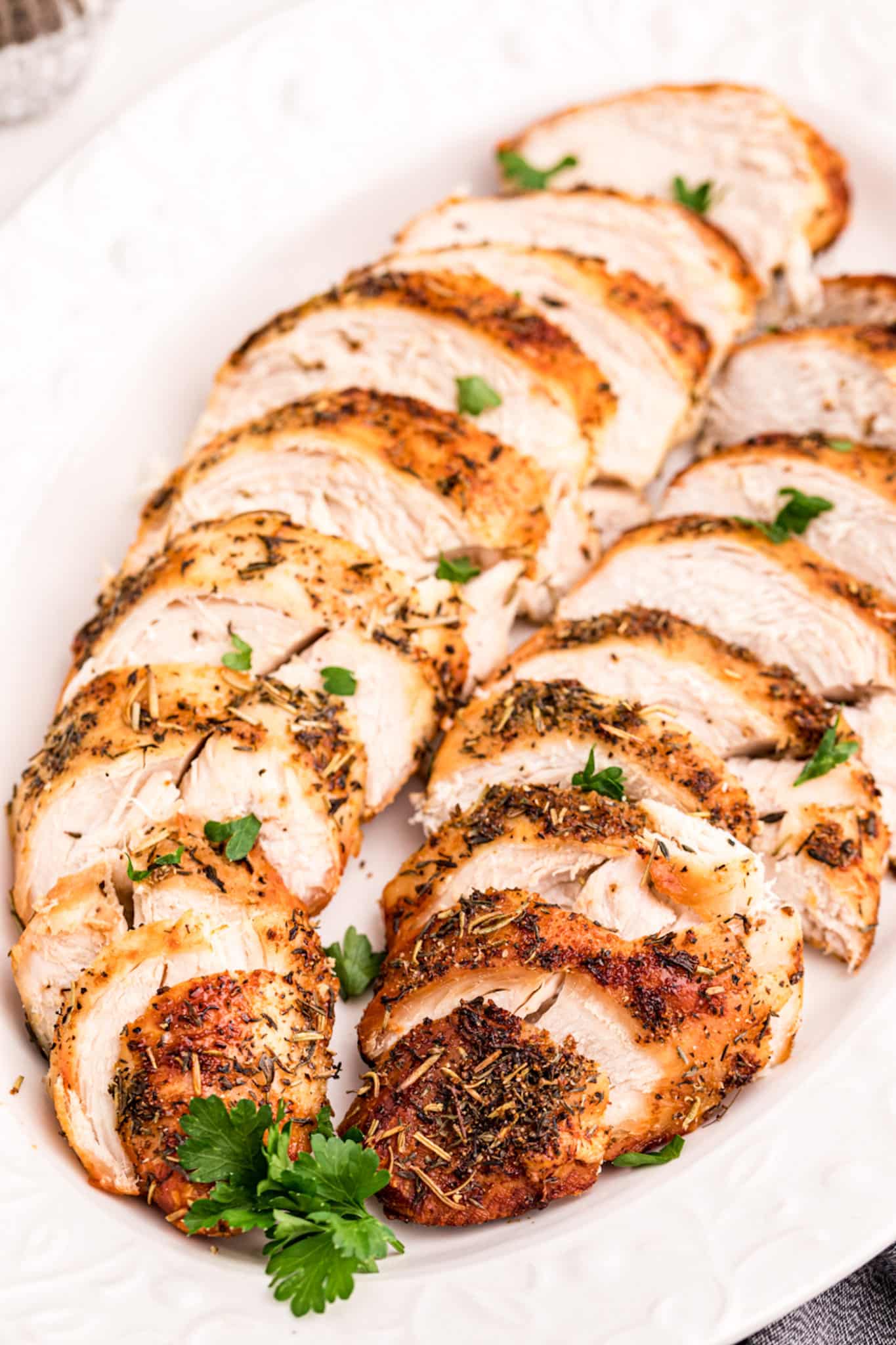 sliced air fryer turkey tenderloins on a serving platter.