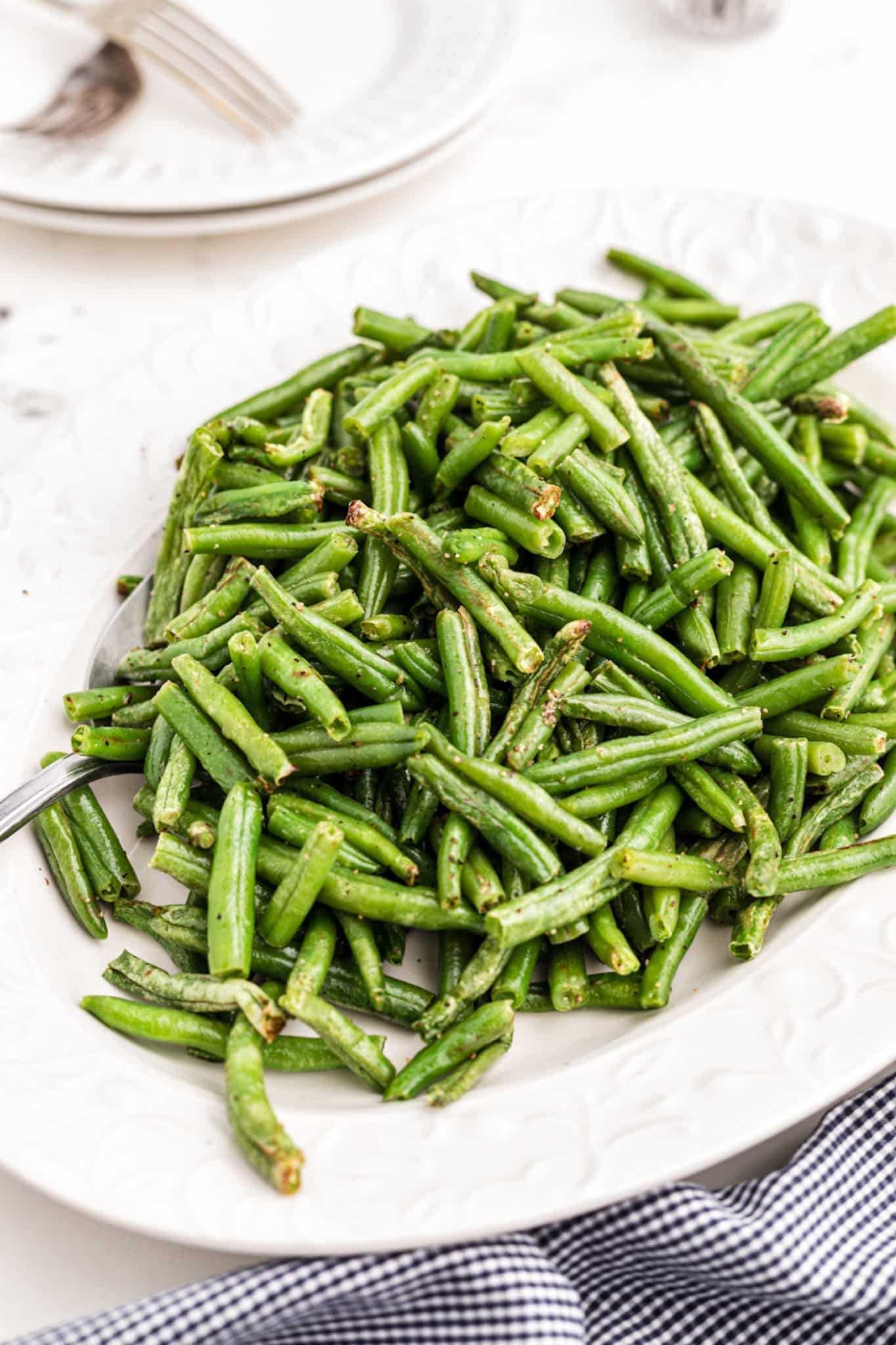 a plate of cooked green beans made in air fryer.