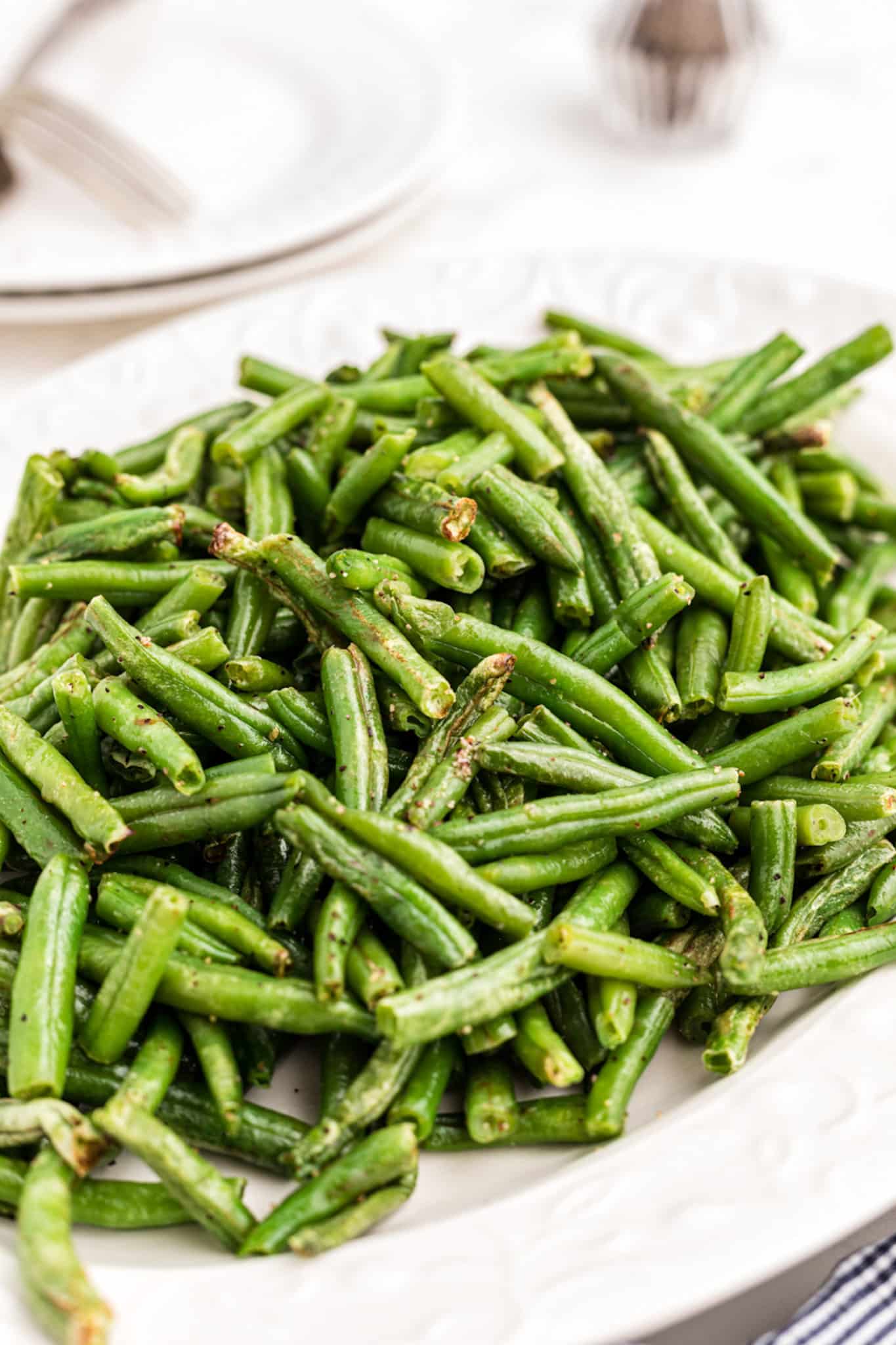 close up of cooked green beans that were made in air fryer basket.