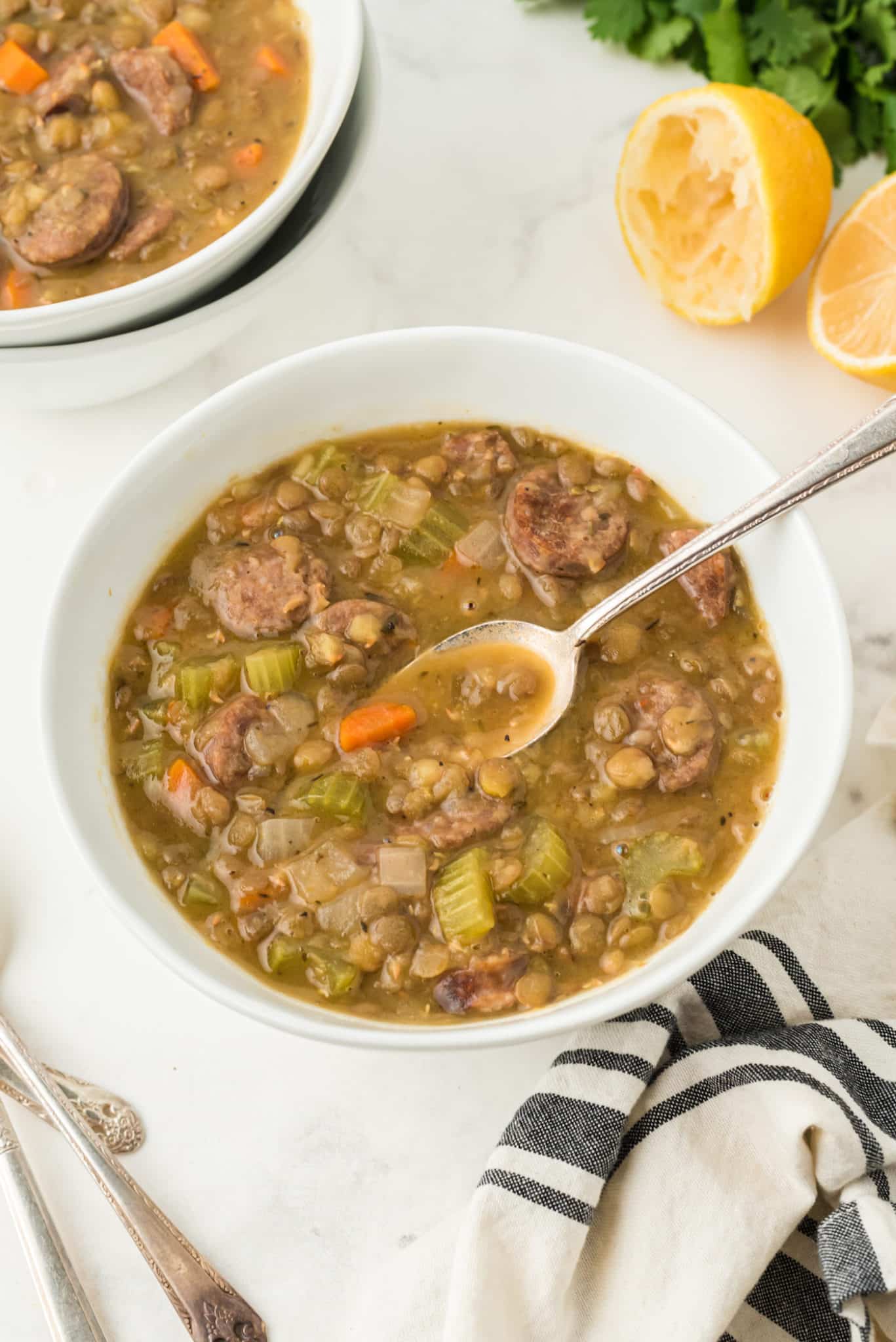 two bowls of lentil soup on a table.