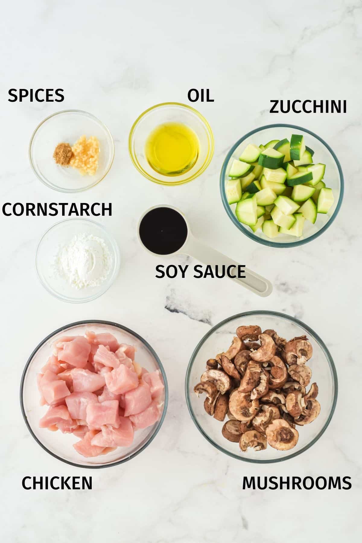 Mushroom chicken Panda Express copycat ingredients in small bowls on a white surface.