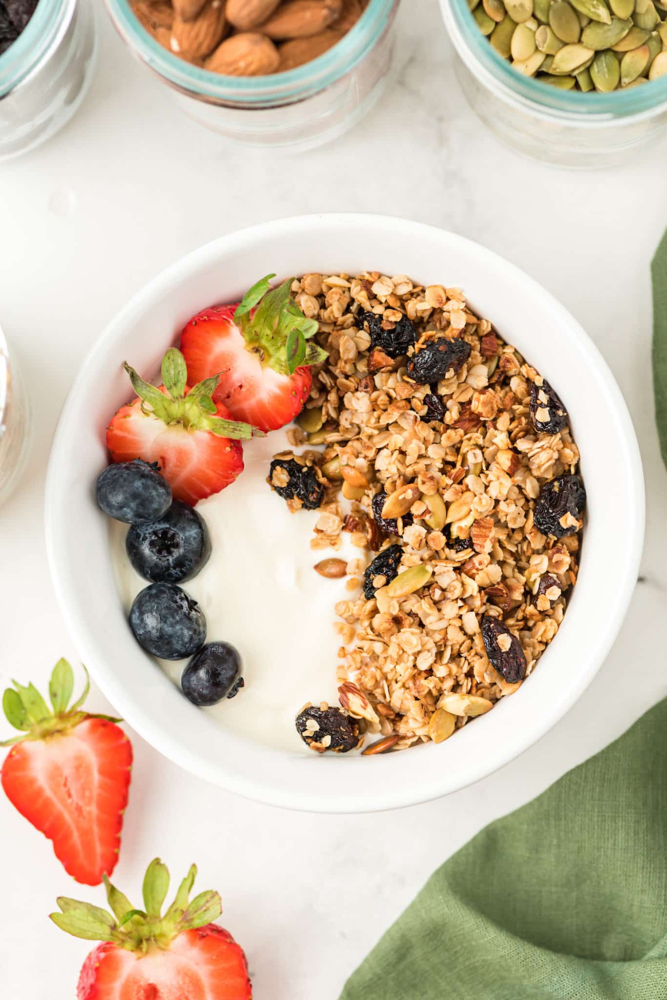 a bowl of yogurt with air fryer granola and fresh fruit.