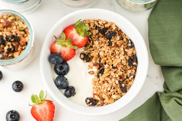 a bowl of yogurt with granola and berries