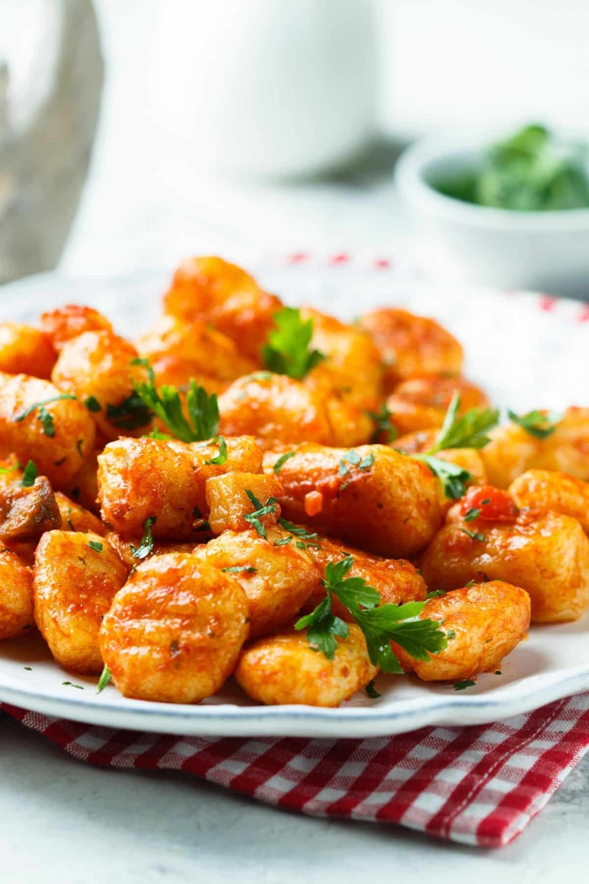 plate of gluten-free vegan gnocchi with marinara sauce.