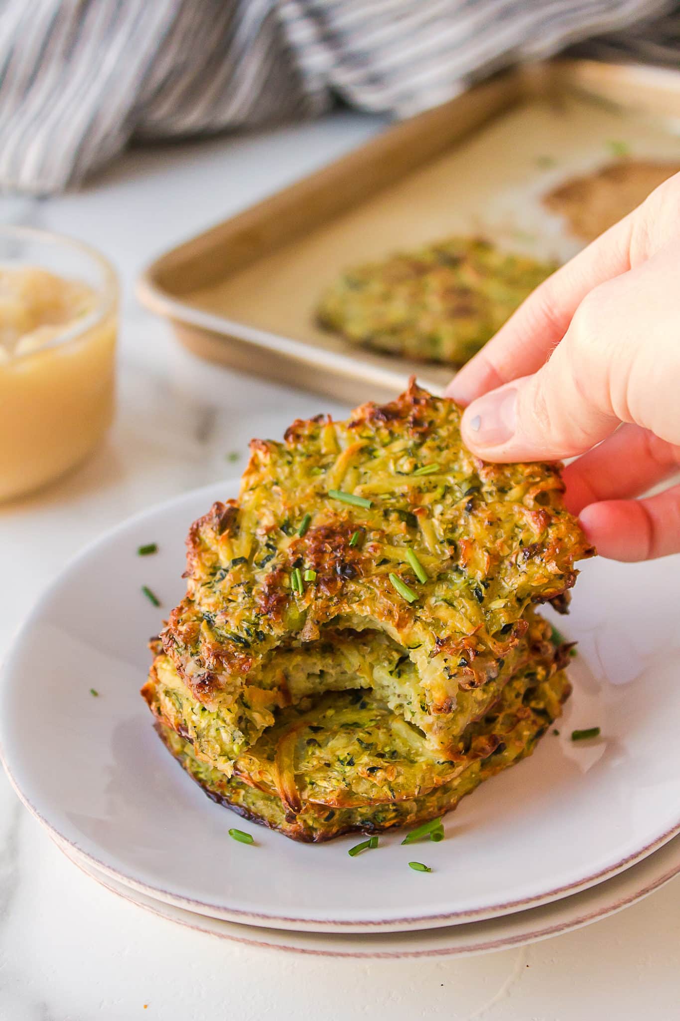 hand holding a zucchini fritter.