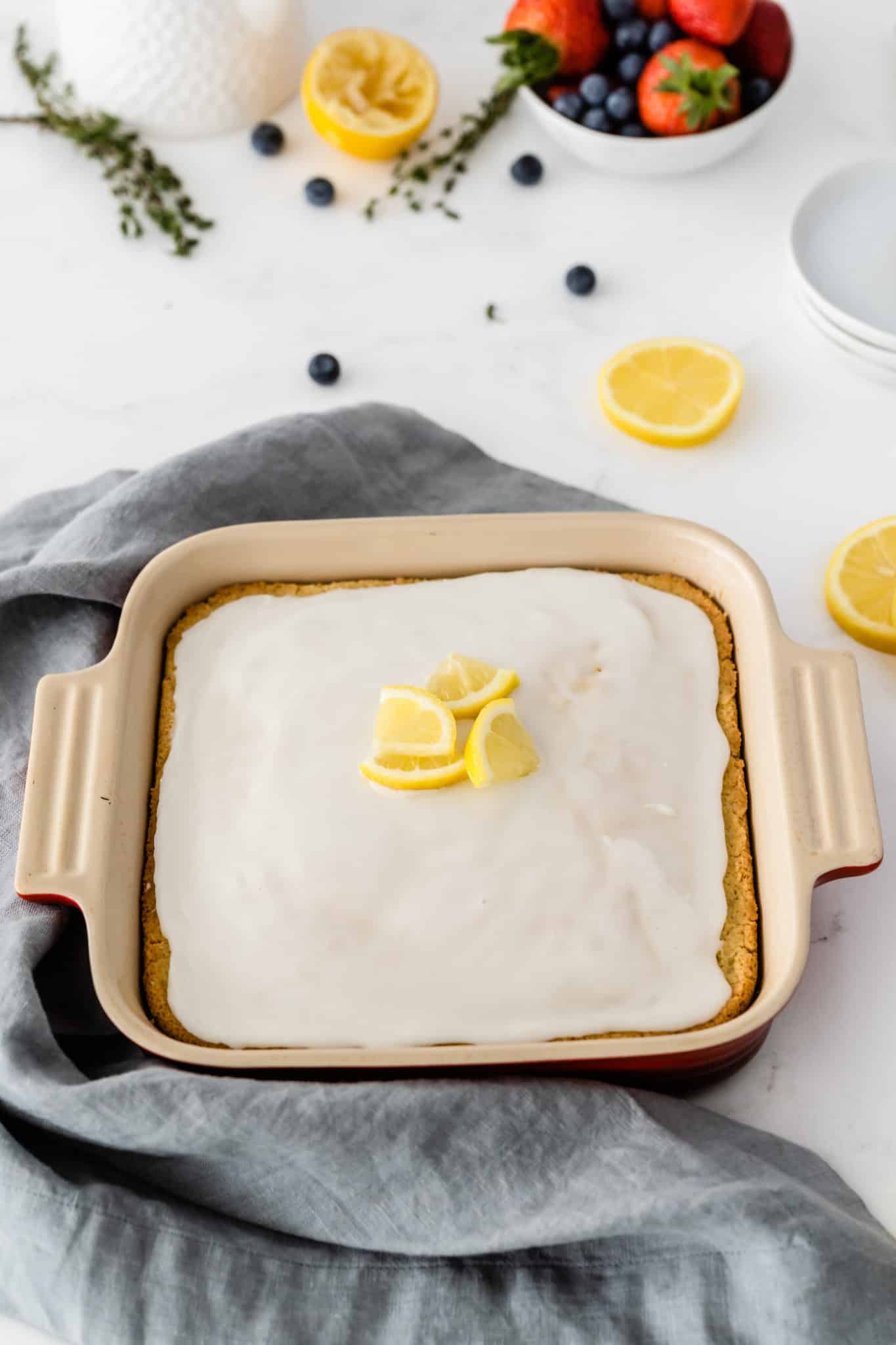 lemon cake with icing ready to be cut and served.