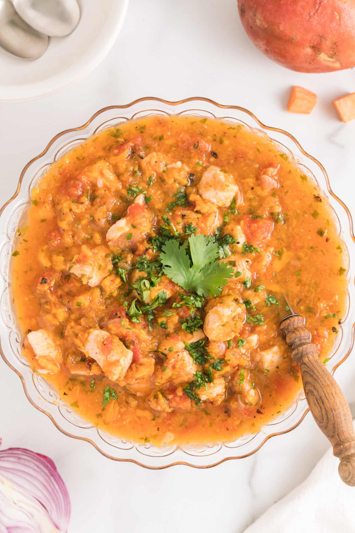 Instant Pot Sweet Potato Chicken and Sweet Potato stew in a glass serving bowl.