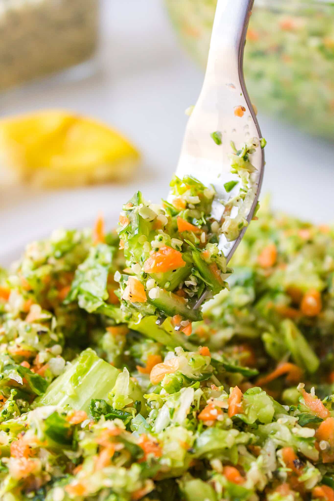 A fork with a bite of chopped veggie salad.