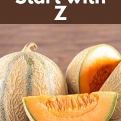 A couple of zebra melons on a wooden surface.