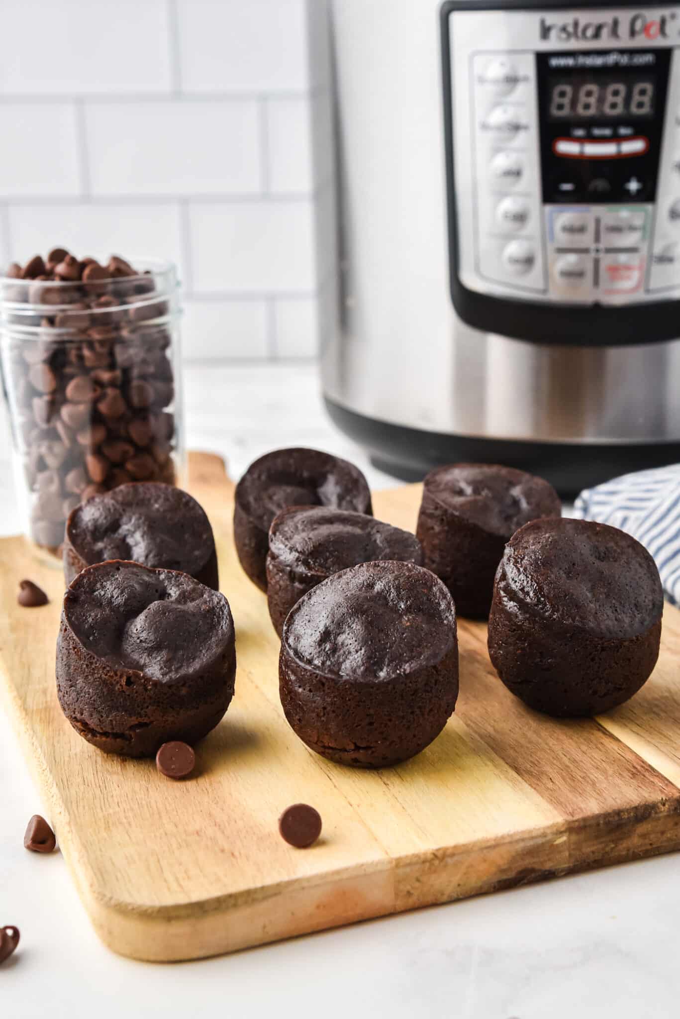 brownie bites cooked and removed from molds on tray next to Instant Pot.