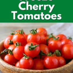 A wooden bowl filled with bright cherry tomatoes.