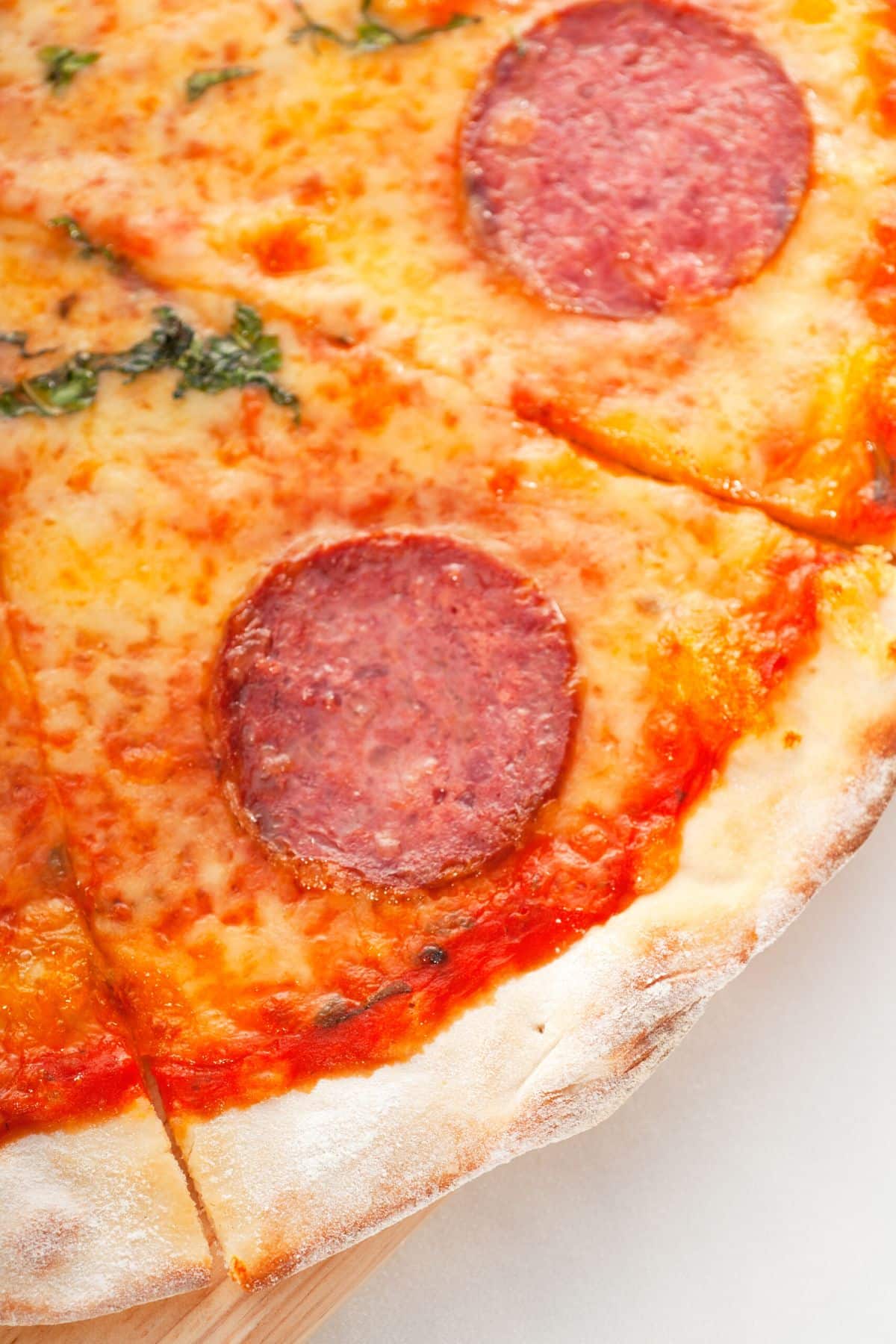 up close photo of a slice of cassava crust pizza.