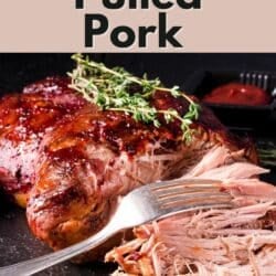 A fork shredding a roasted pork loin.