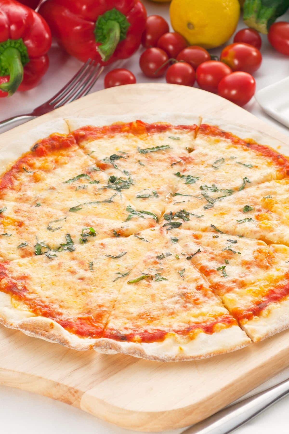thin crust cassava pizza on cutting board.