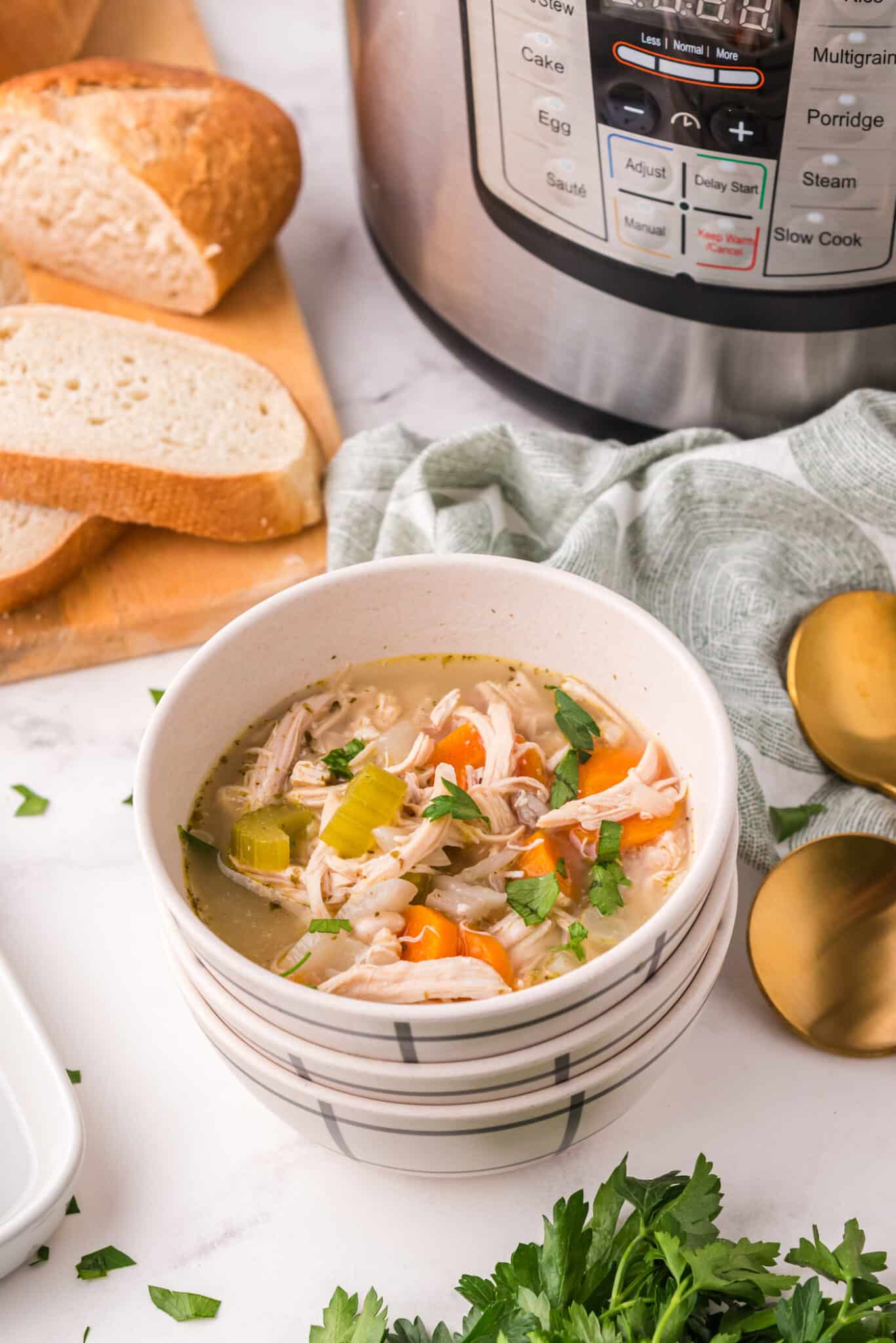 A small white bowl filled with homemade turkey vegetable soup.