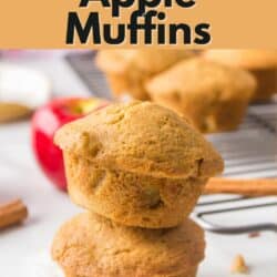 Two gluten free apple muffins stacked on a counter.