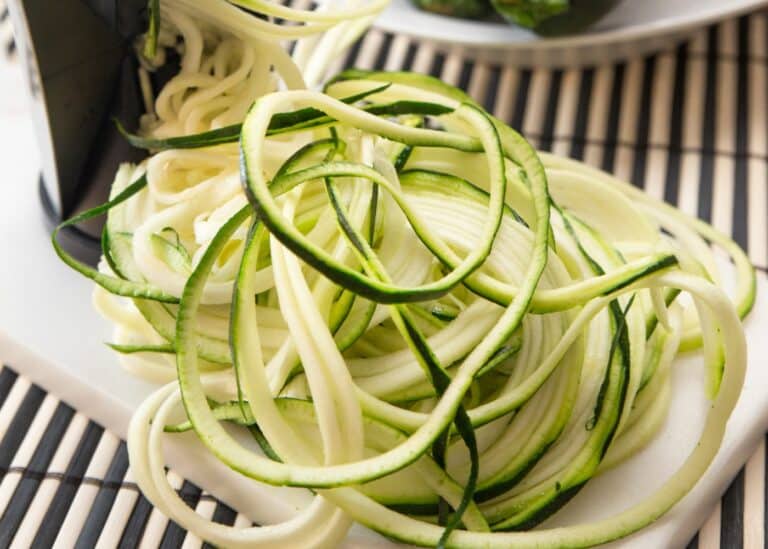 Spiralized zucchini in a pile on a counter.