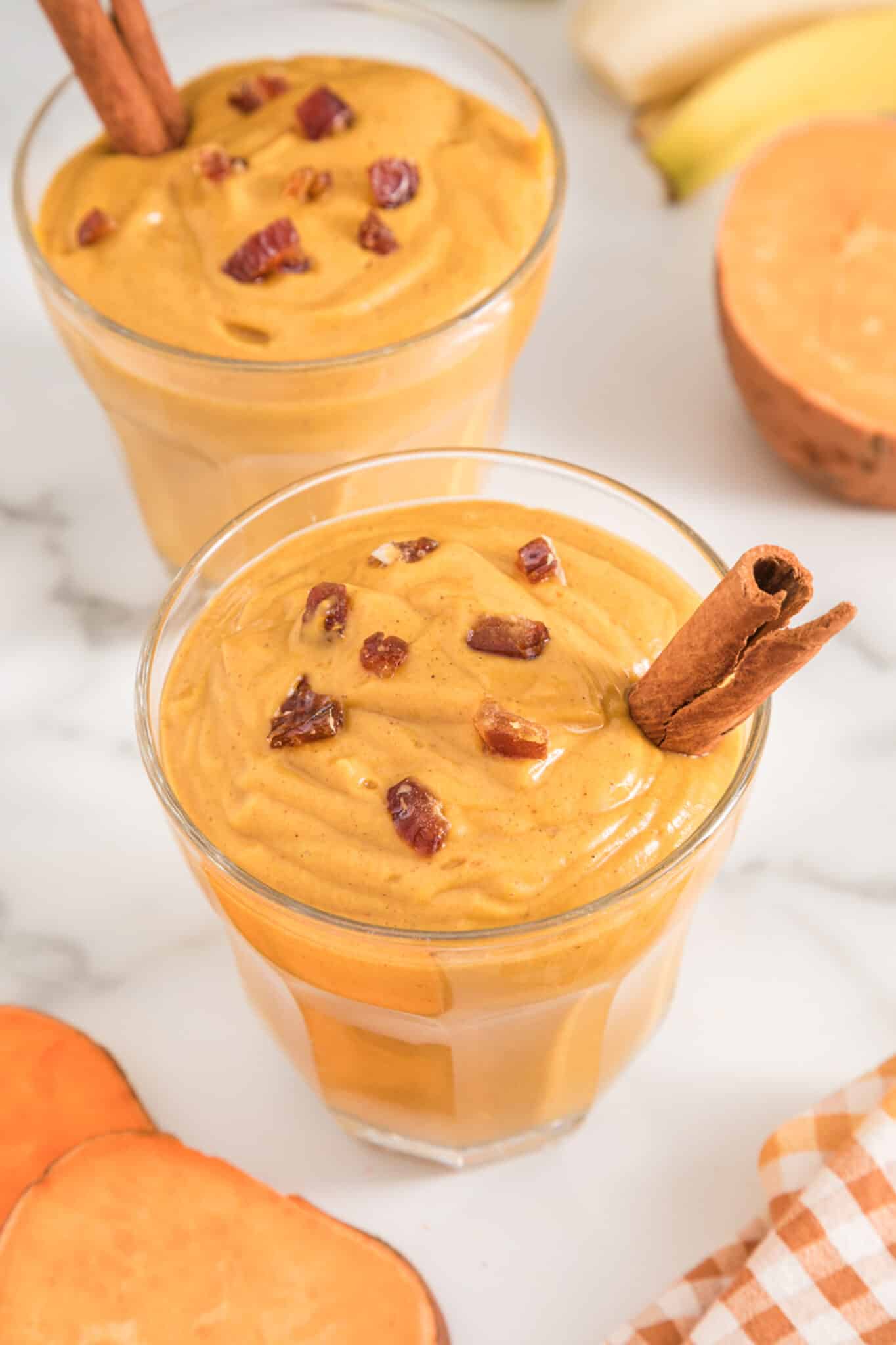 Two short glasses of vegan sweet potato smoothie.