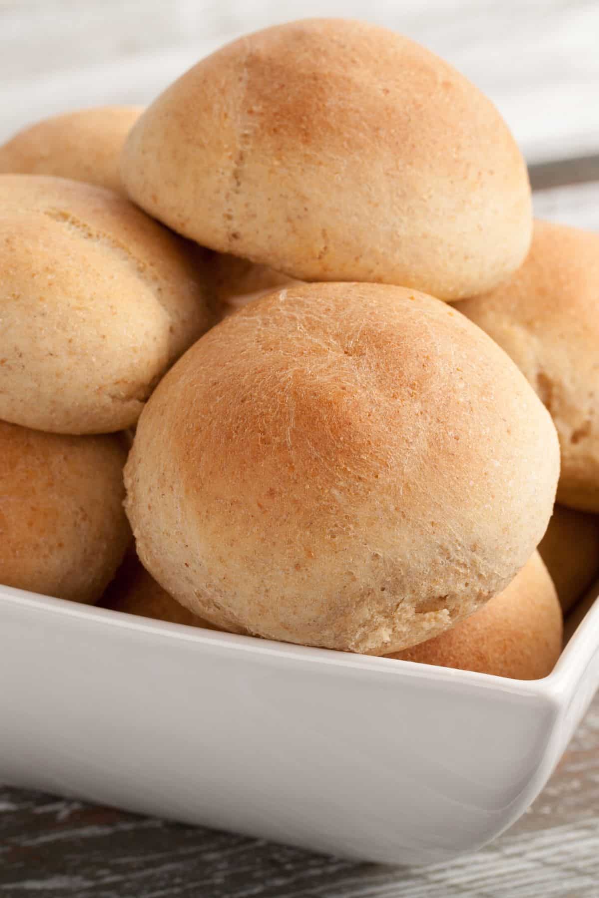 baked gluten free dairy free dinner rolls in bowl.
