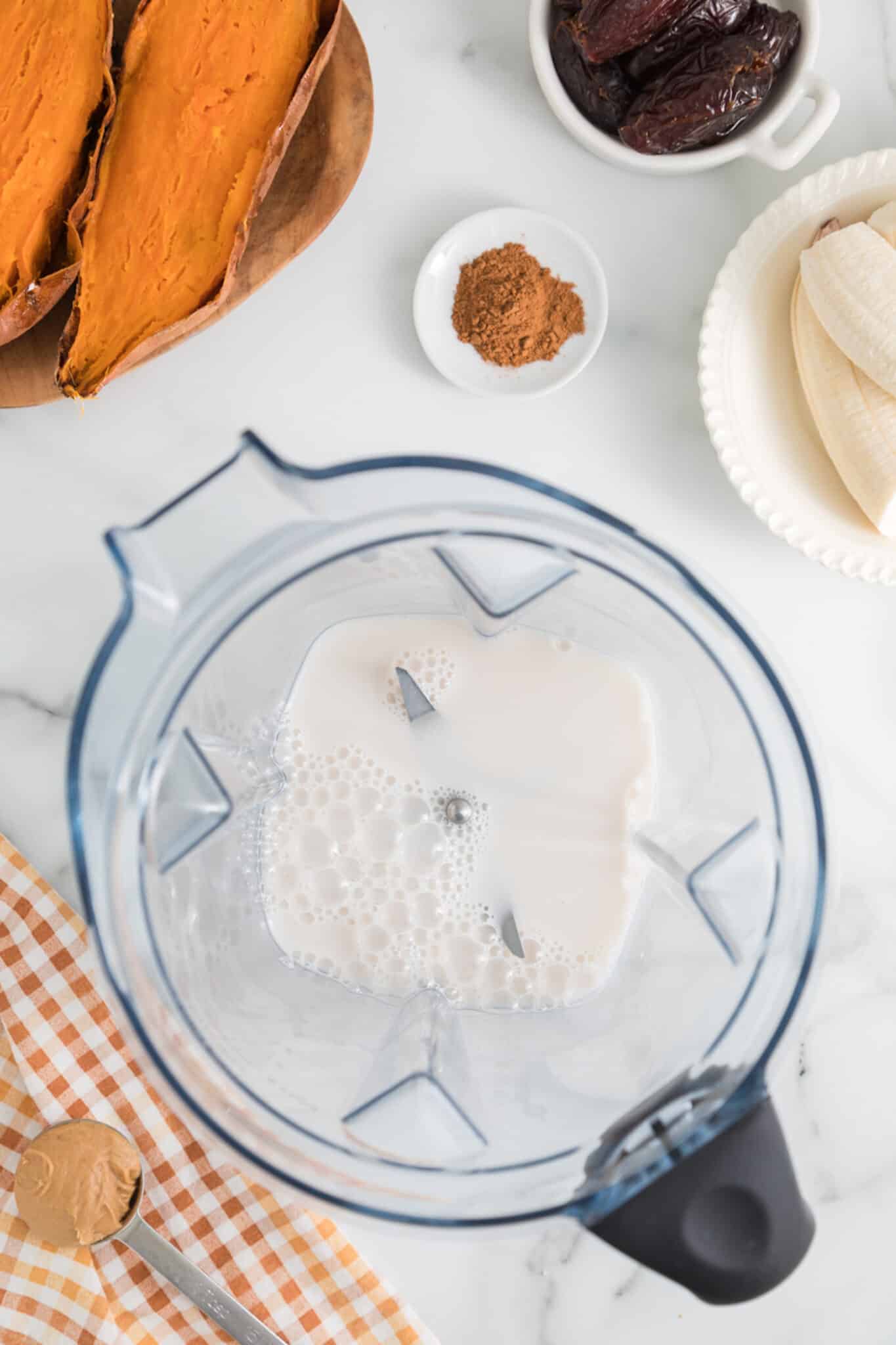 Milk in the jar of a high-powered blender.