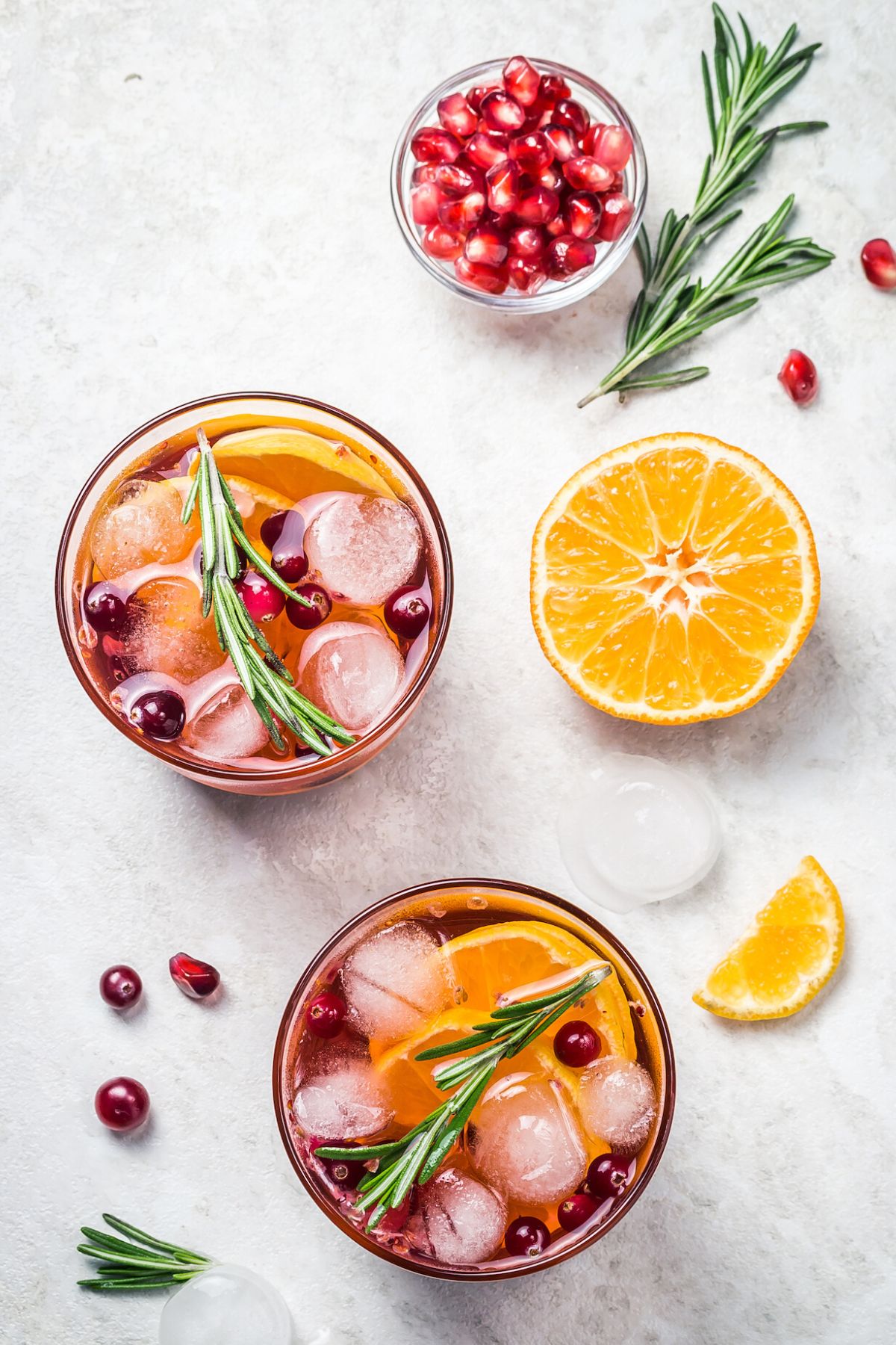 two glasses pomegranate mocktail.