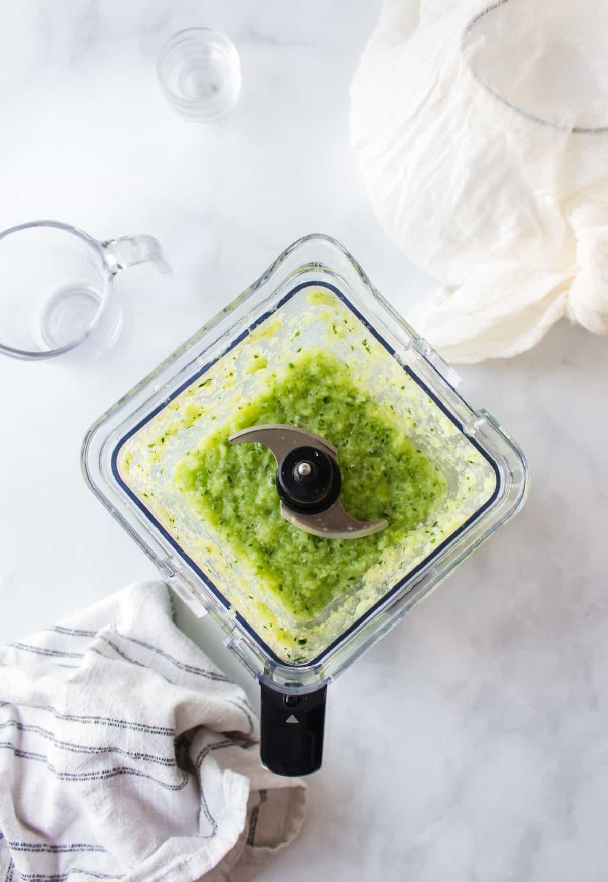 blended green cabbage juice in pitcher before straining.